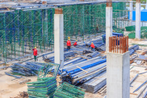 Construction workers installing scaffolding on construction site