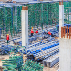 Construction workers installing scaffolding on construction site